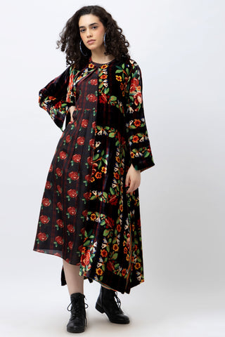 Woman wearing a black floral dress on a white background